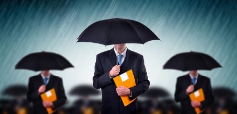 7558411 - businessman with umbrellas in heavy rain.